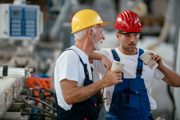 istock Manual workers having a coffee break in industrial building 1132721547