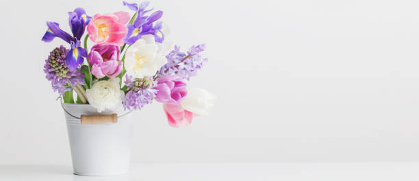 istock spring flowers in bucket on white  background 1132721655