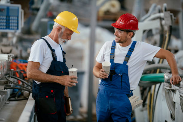 istock Manual workers having a coffee break in industrial building 1132721828