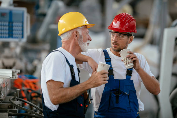 istock Manual workers having a coffee break in industrial building 1132721911