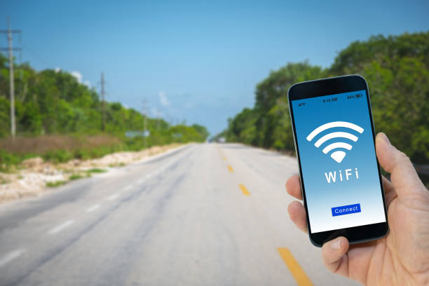 istock Hand holding a black smartphone with button connect to wireless internet hotspot on screen 1132724935