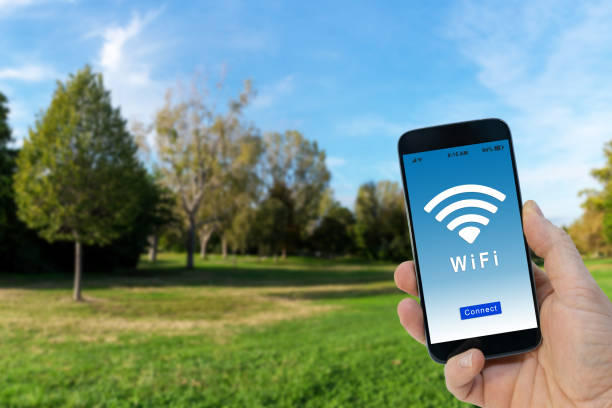 istock Hand holding a black smartphone with button connect to wireless internet hotspot on screen 1132724968