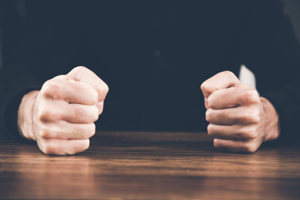istock angry man fists on table 1132725495