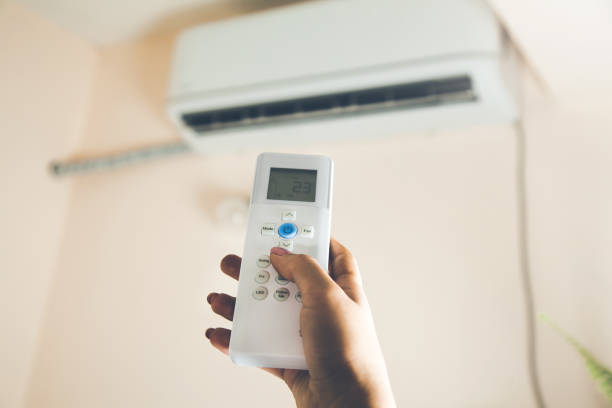 istock woman hand using a remote control to activating air conditioning 1132725502