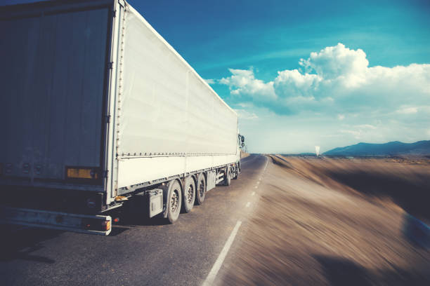 istock truck on road at sunset 1132725509