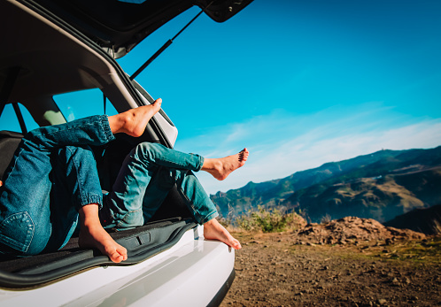 kids relax while travel by car in nature, family vacation in mountains, travel concept