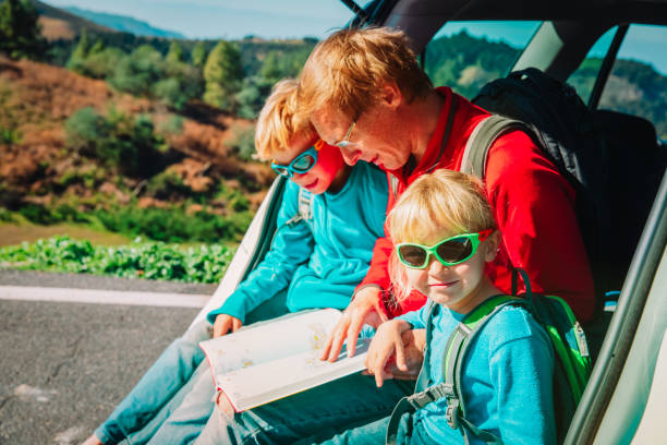 istock father with kids looking at map while travel by car 1132726925