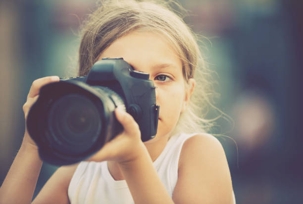 istock girl holding photo camera 1132728153