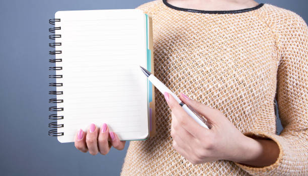 istock notebook pen and  writing girl 1132730686