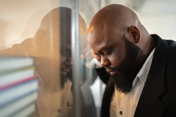 istock Frustrated afro man feeling loser standing near the window 1132731799
