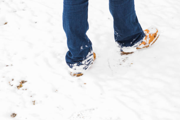 istock A person with boots walking through the snow 1132732036