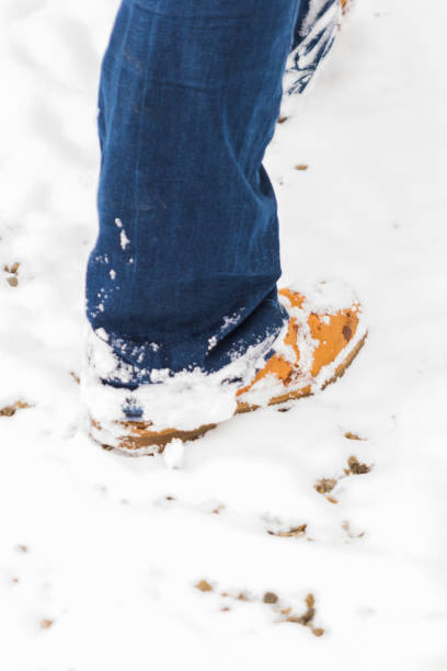 istock A person with boots walking through the snow 1132732038