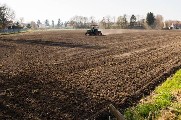 istock tractor plowing the land for the next crop 1132732067