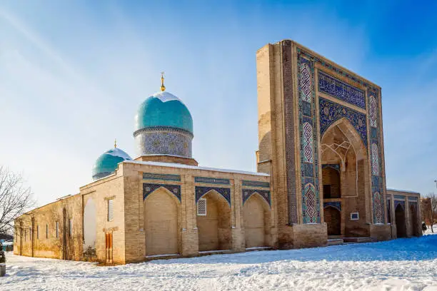 Decorated entrance and two domes of Hazrati Imam complex, religious center of Tashkent, winter time, Uzbekistan