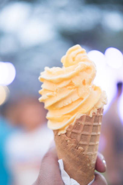 istock Melted ice cream flavor of passion fruit on a waffle cone 1132733145