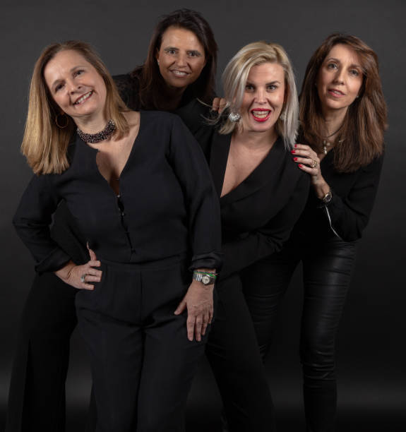istock Four friends posing in a studio with a black background 1132733769