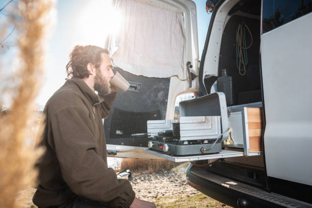 istock Man next to his camper van having a cup of coffee 1132736290