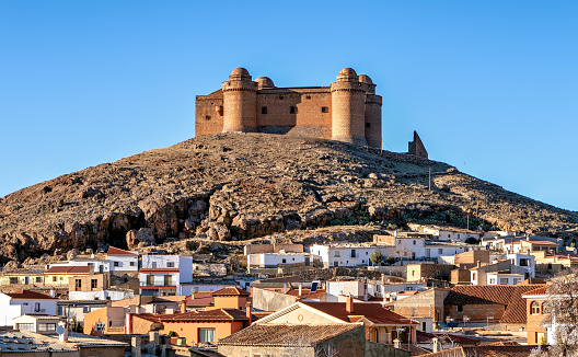 View of historic La Calahorra castle standing on a hill above the village with the same name in the province of Granada, Spain.