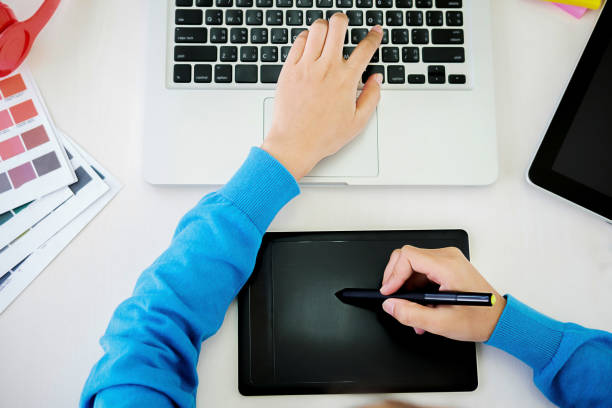istock Graphic design and color swatches and pens on a desk. Architectural drawing with work tools and accessories. 1132738159