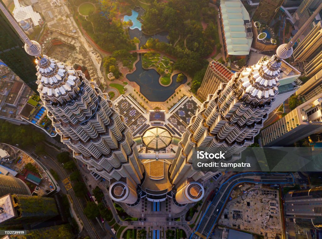 Top of Petronas Twin Towers. Aerial view of Kuala Lumpur Downtown, Malaysia. Financial district and business centers in smart urban city in Asia. Skyscraper and high-rise buildings at sunset. Kuala Lumpur Stock Photo