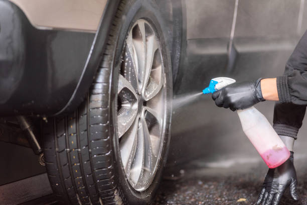 istock Professional car washer cleaning alloy wheels. 1132740343