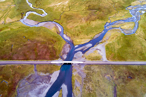 Aerial view of a bridge over braided river and country road in Snaefellsnes, Iceland.