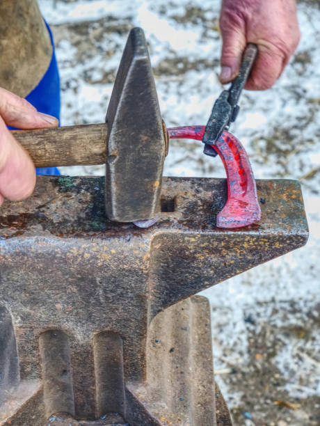 istock Blacksmith forges hot horseshoe. Farrier works 1132741858