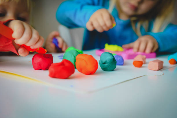 istock kids play with clay molding shapes, learning through play 1132742202