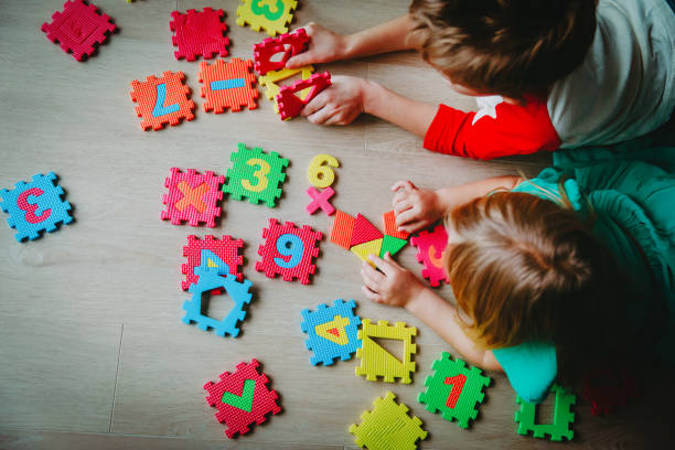 istock kids playing with number puzzle, education concept 1132742282