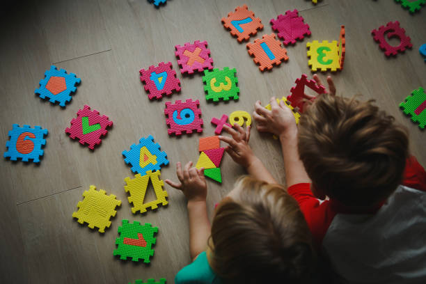 istock kids playing with number puzzle, education concept 1132742884