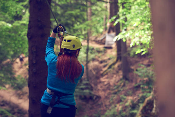 istock rear view of woman zip lining 1132743063
