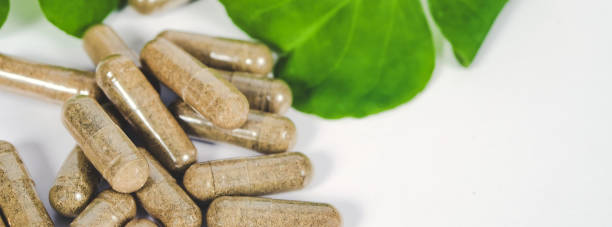 istock Alternative herb capsule and fresh herb background ,health concept. 1132743165