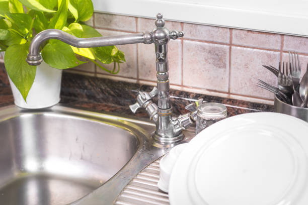 istock The Clean dishes are drying, on rustic kitchen metal sink. 1132743829
