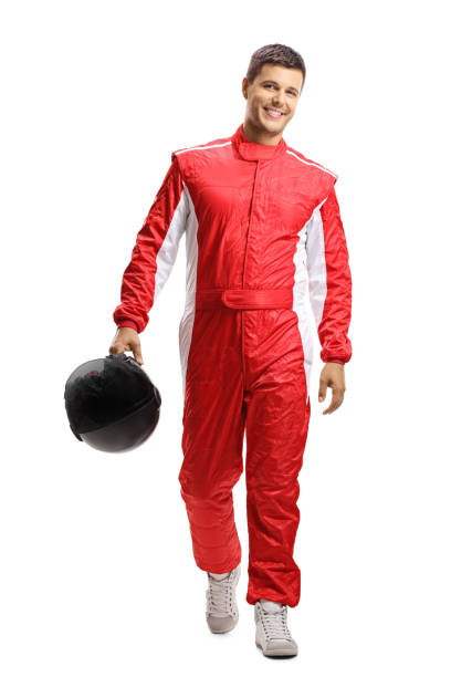 Male car racer holding a helmet and walking towards the camera Full length portrait of a male car racer holding a helmet and walking towards the camera isolated on white background race car driver stock pictures, royalty-free photos & images