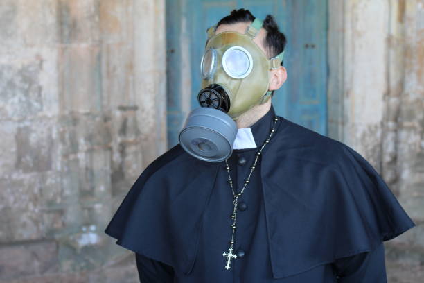 priest wearing a gas mask - bad habit imagens e fotografias de stock