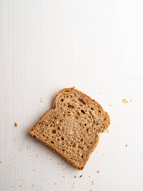 Bread slices,Multigrain bread slice Bread, Toasted Bread, Celebratory Toast, Slice of Food, White Background,food,Brown Bread slice of bread stock pictures, royalty-free photos & images
