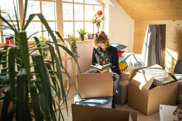 istock Woman Unpacking boxes at her new home 1132749995