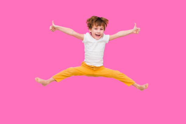 boy is on white background his arms are open and he is smiling vertical kid still