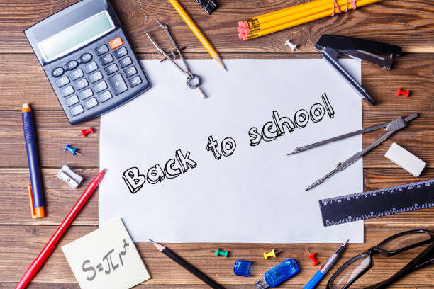 istock Album sheet with text - back to school and student material on wooden table. 1132753328