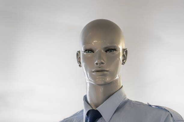 store male mannequin in chrome face depicting modern and futiristic fashion in storefront show window