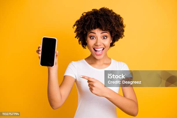 Portrait Of Her She Nice Attractive Lovely Charming Cheerful Cheery Ecstatic Wavyhaired Lady Holding In Hands Cell Showing Black Screen Isolated On Bright Vivid Shine Yellow Background Stock Photo - Download Image Now