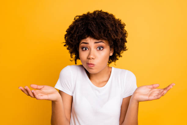 close-up portret van haar ze mooie aantrekkelijke verbaasd onwetende golvend harig meisje toont gebaar geen informatie geïsoleerd op heldere levendige glans gele achtergrond - schouders ophalen stockfoto's en -beelden