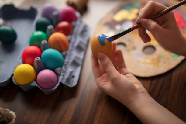 istock DIY young woman paints colorfull easter eggs 1132758576