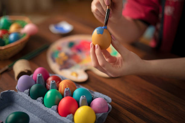 istock DIY young woman paints colorfull easter eggs 1132758643