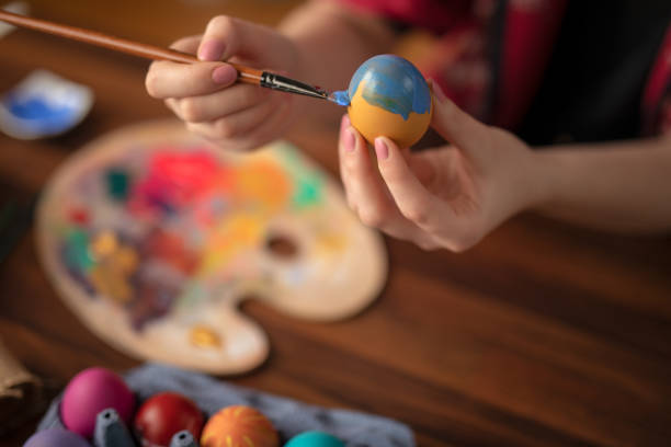 istock DIY young woman paints colorfull easter eggs 1132758892
