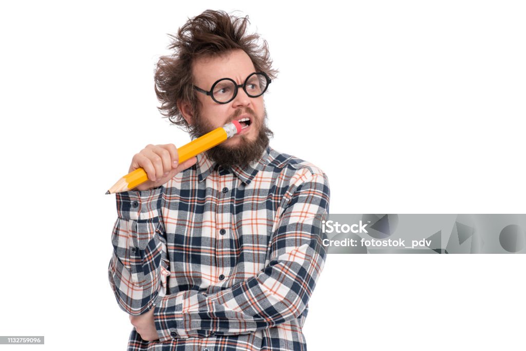 Crazy bearded man with big pencil Crazy thoughtful bearded Man in plaid shirt with funny Haircut in eye Glasses holding Big Pencil - ponder and dreaming, isolated on white background. Humor Stock Photo