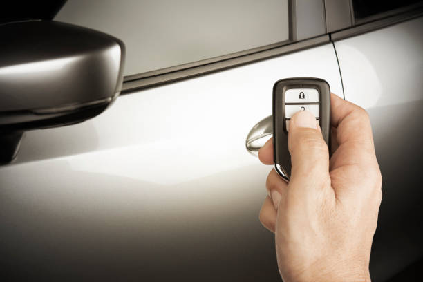 istock Hand of man holding and push remote control car open the door or  central locking technology transportation safety concept 1132759976