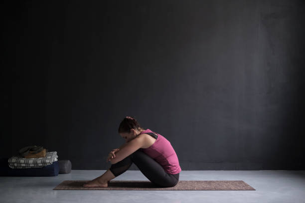 istock Young woman working out against blackwall, doing yoga or pilates exercise 1132760141