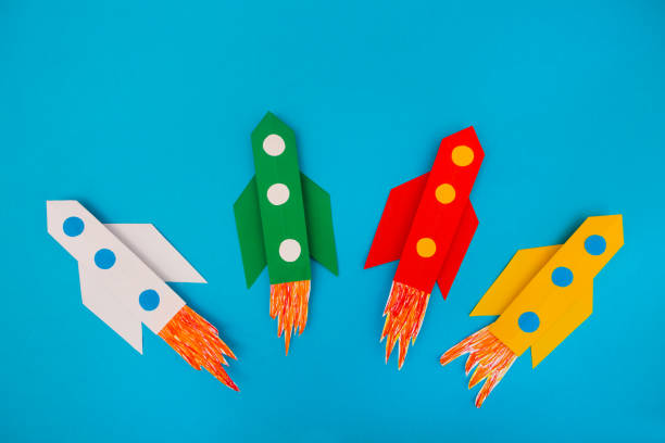 istock top view of flying multi-colored rockets from paper on a blue background 1132761924