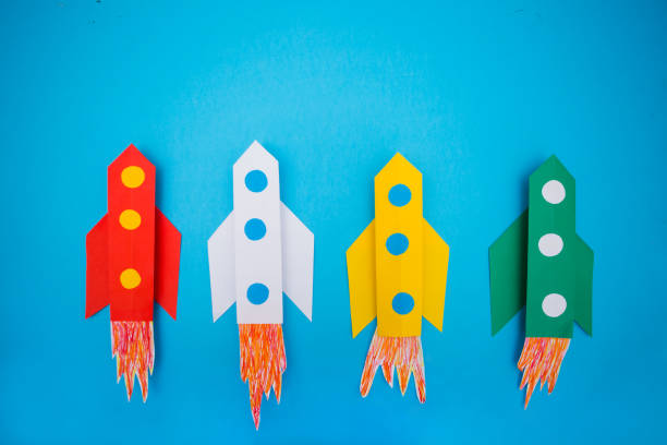 istock top view of flying multi-colored rockets from paper on a blue background 1132761929